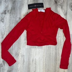 Red long sleeve crop top. Zips in the front